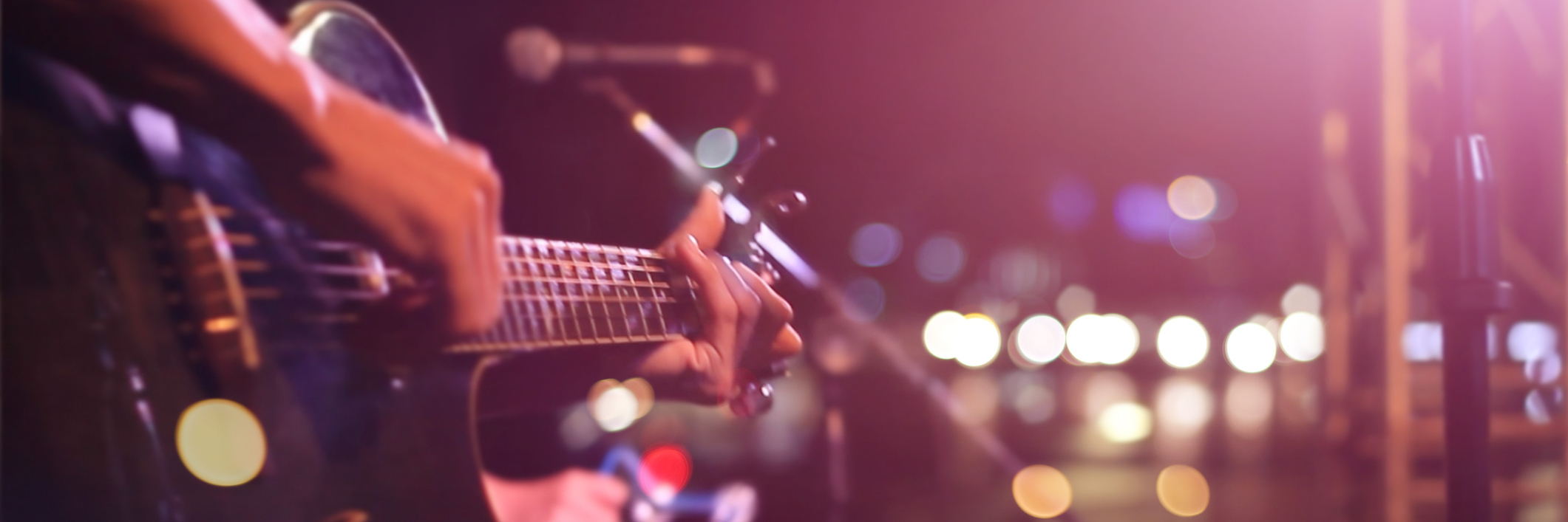 3 Things Performing Music and Performing 'Healthy' Have in Common Guitarist on stage for background, soft and blur concept