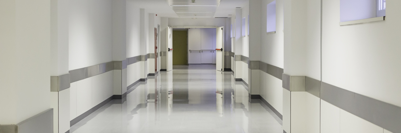 Why We Should Treat Mental Health Like Mammograms Empty hospital hall with white walls, medicine