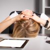 Woman with her head on her desk.