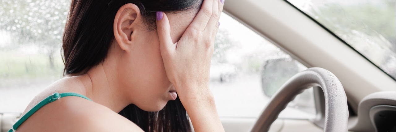 Today I Had a Panic Attack While Driving tired stressed upset woman driver with hands covering eyes