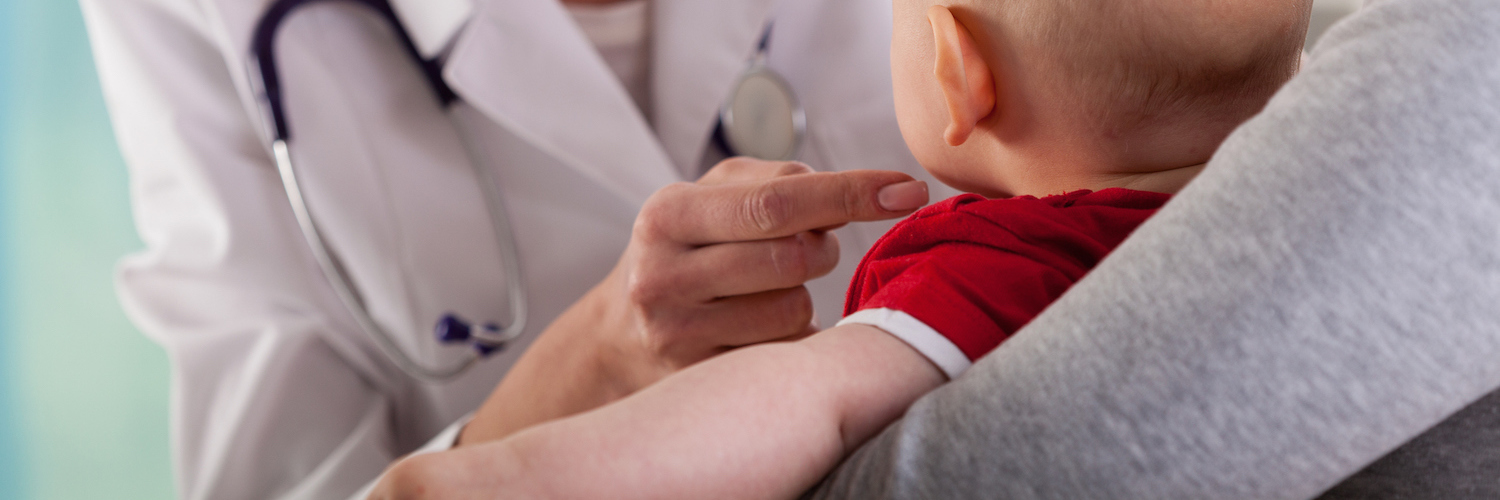 Baby boy with mother at doctor's office