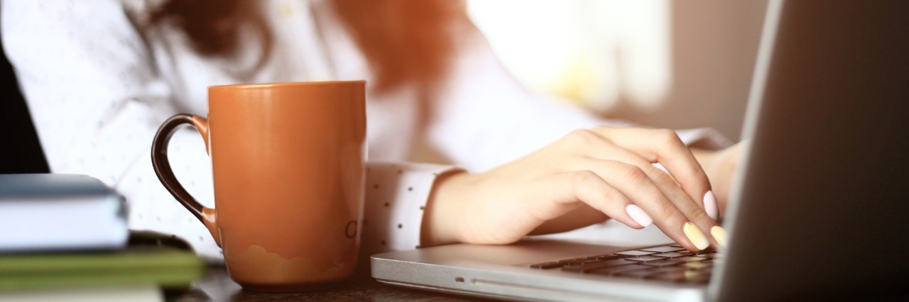 Fibromyalgia, Lupus: Posting About Illness on Social Media woman typing on laptop