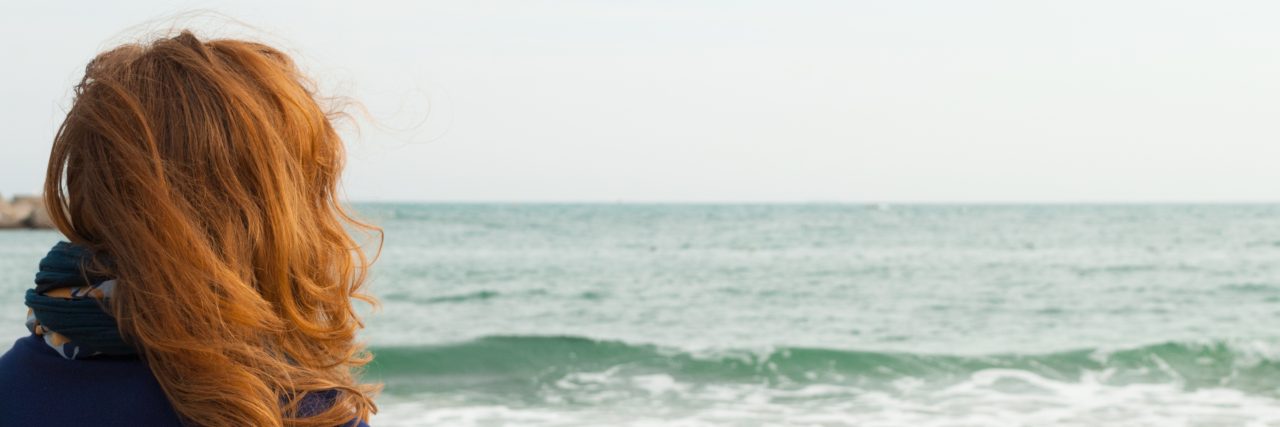 How I'm Rekindling Friendships I Lost to Illness Redhead girl on a Barcelona sand beach