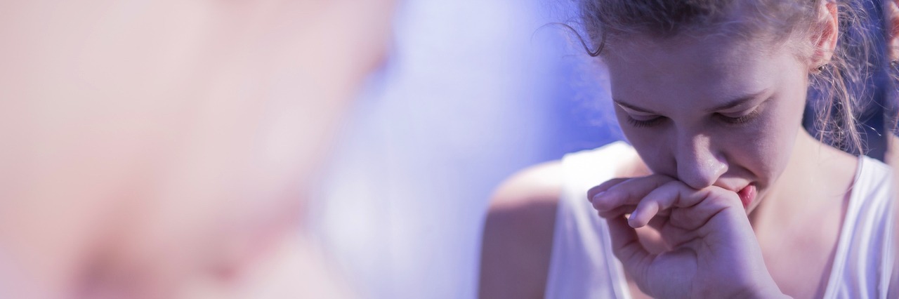 I Didn't Look 'Sick Enough' To Have An Eating Disorder A woman looking at herself in the mirror