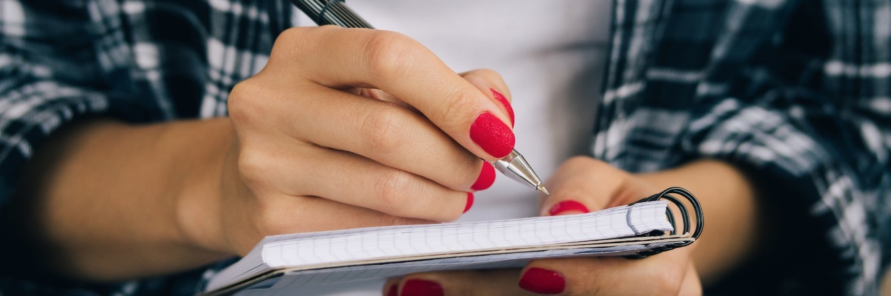 Benefits of Keeping a Health Journal woman writing in notebook