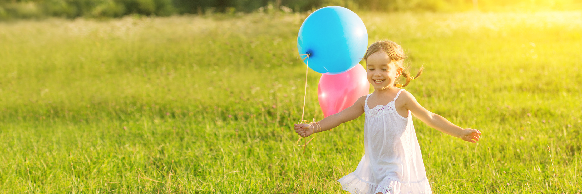Searching for Old Self That Existed Before Dysautonomia young girl laughing and running through a field with balloons