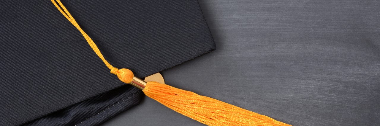 The Grief After Suicide I Experienced During Graduation Season graduation cap with gold tassel on blackboard background