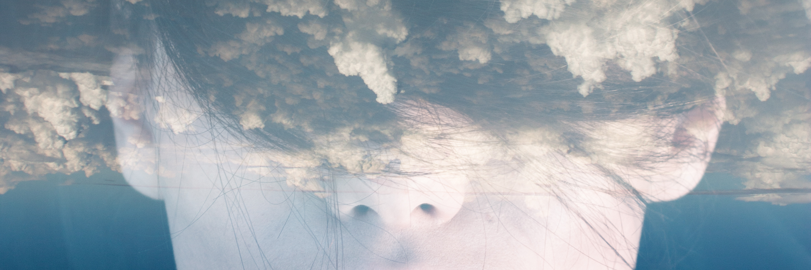 Invisible Parts of Chronic Illness, What People Can't See woman's face with double exposure of clouds covering her eyes