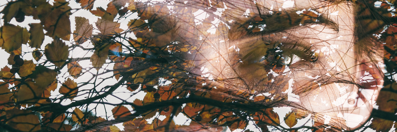 I Miss Who I Was Without OCD A woman hiding behind leaves