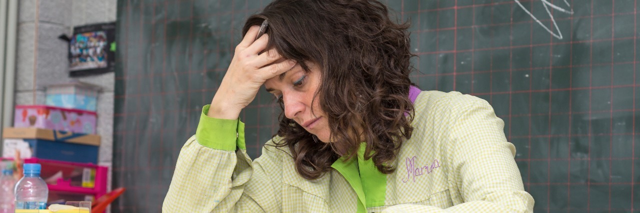 Why Teachers' Mental Health Is at Risk stressed tired female teacher in classroom