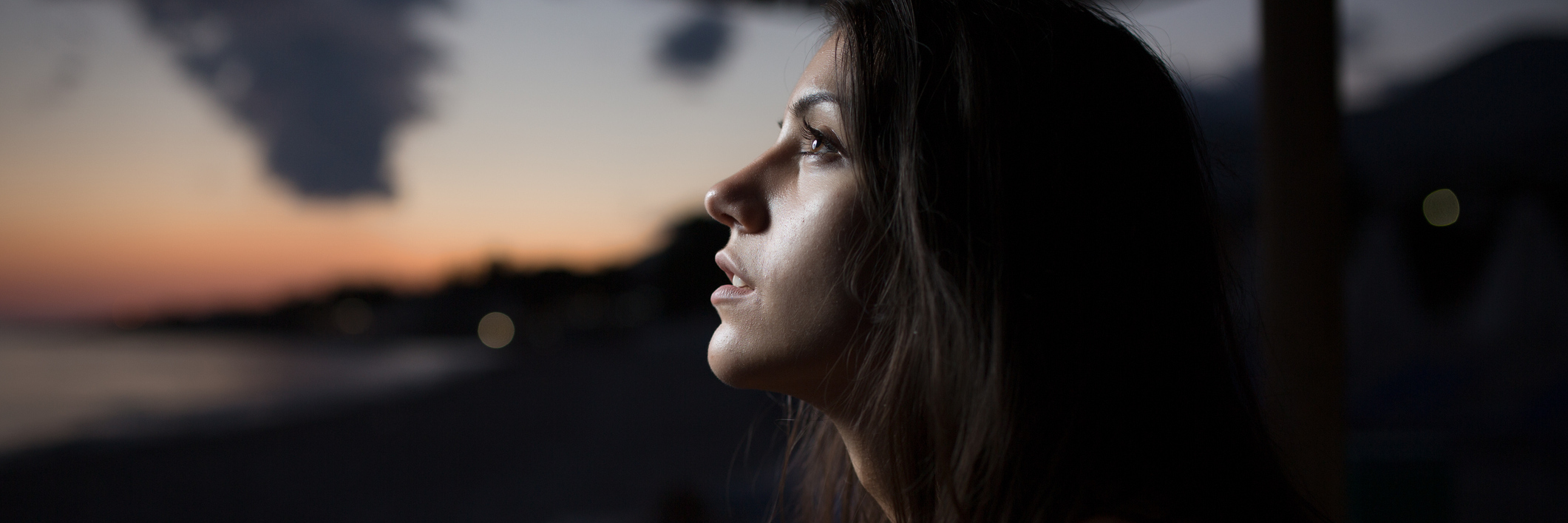 The Process of Accepting My Chronic Illness Woman looking out towards the sunset.