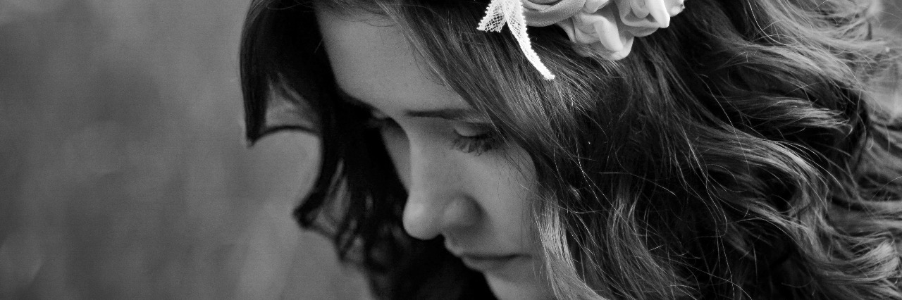 I Will Always Be Sick – Even If I Look 'Fine' A black and white image of a woman with a serious, unhappy expression.