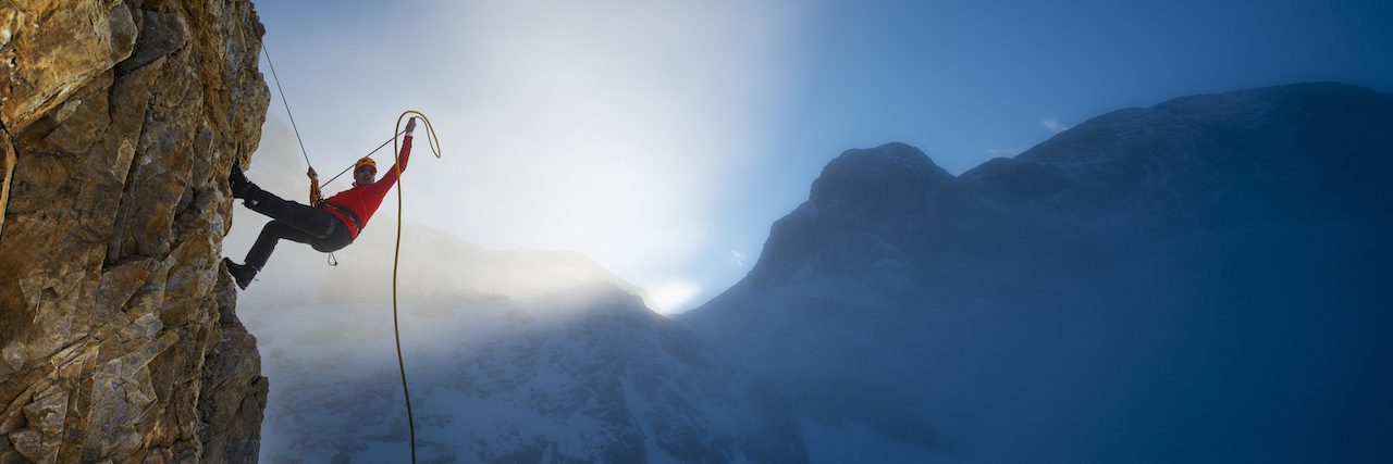 man climbing a mountain