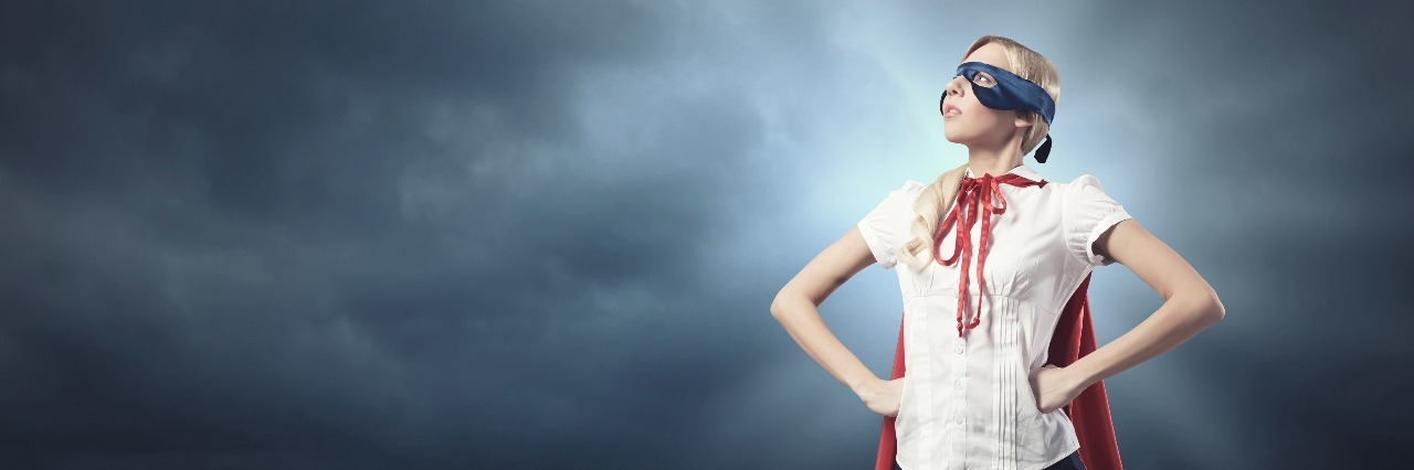 8 Ways Ehlers-Danlos Syndrome Makes Me a Superhero Young woman with superhero outfit outside, looking to the sky.