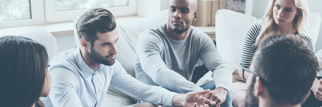 How Self-Harm Support Groups Can Be Helpful support group sitting in circle while one man talks about problems