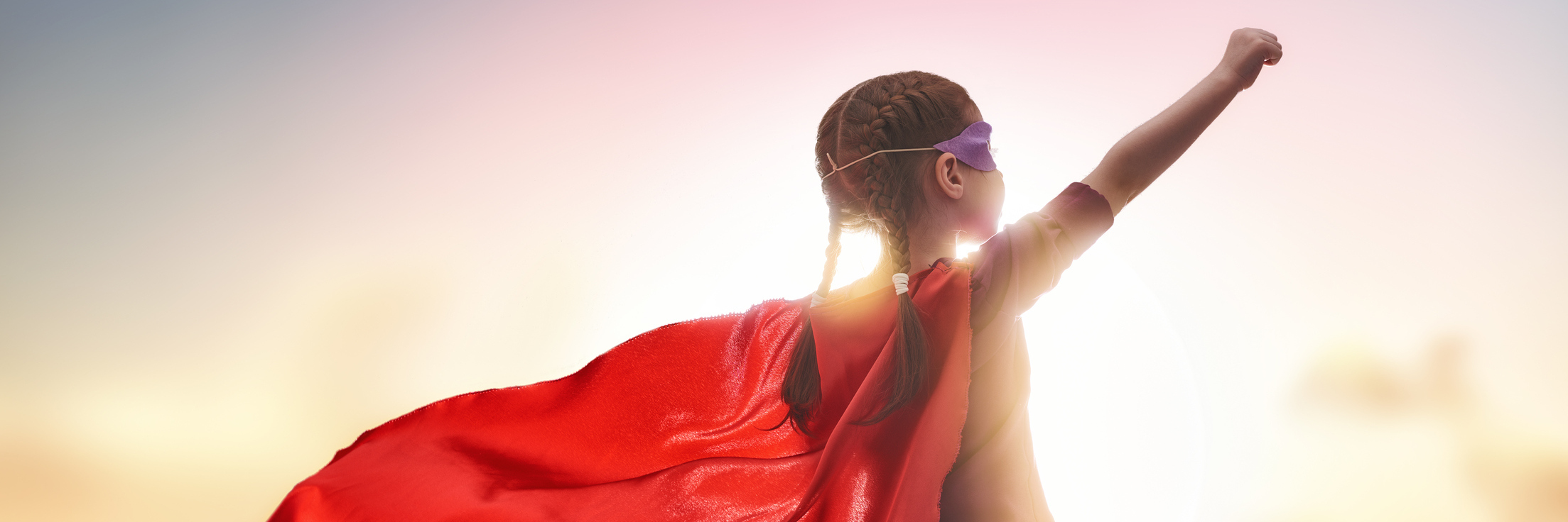 Everyday 'Superpowers' to Help Support a Friend With Mental Illness Little child plays superhero. Kid on the background of sunset sky. Girl power concept