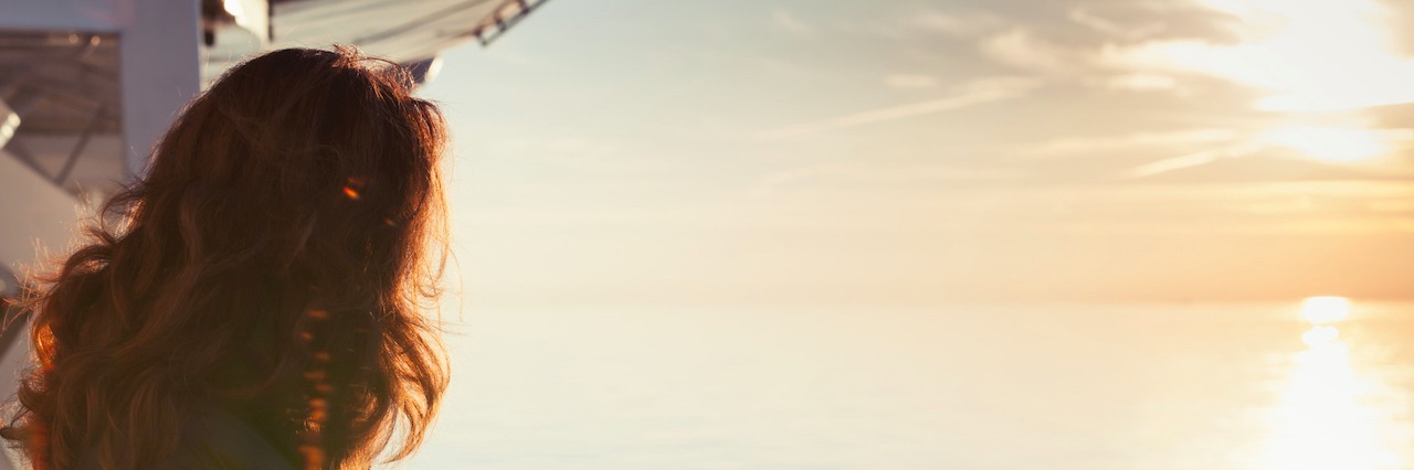 'Not Sick Enough' to Get Eating Disorder Treatment A woman standing on a boat looking at the water