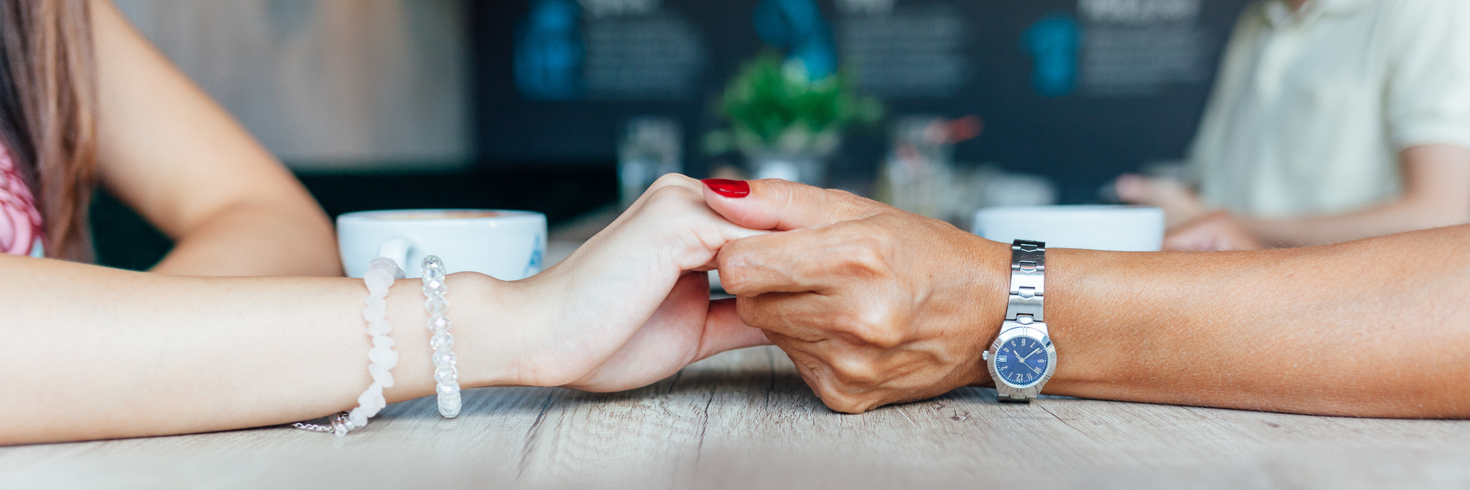When Mother and Daughter Are Both Chronically Ill mother and daughter holding hands over a table