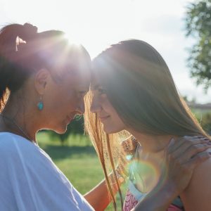 A mother and daughter embracing outside