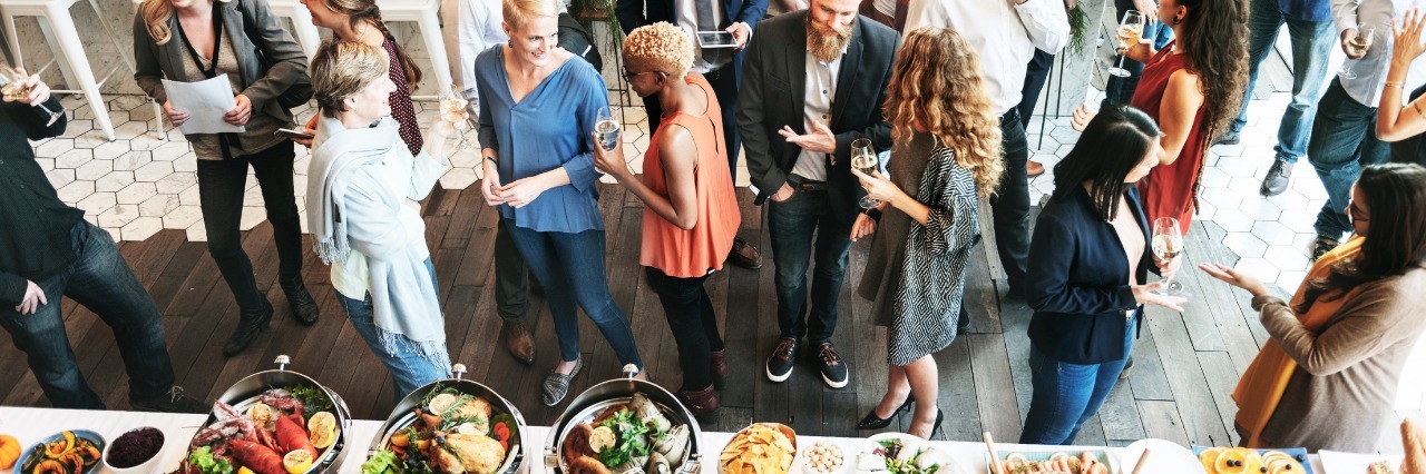 Staying Away From Foods That Exacerbate Chronic Pain business people talking next to buffet of food at the office