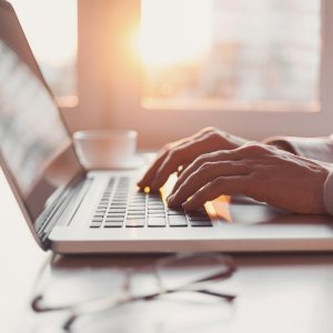 Businessman using smart phone and laptop computer