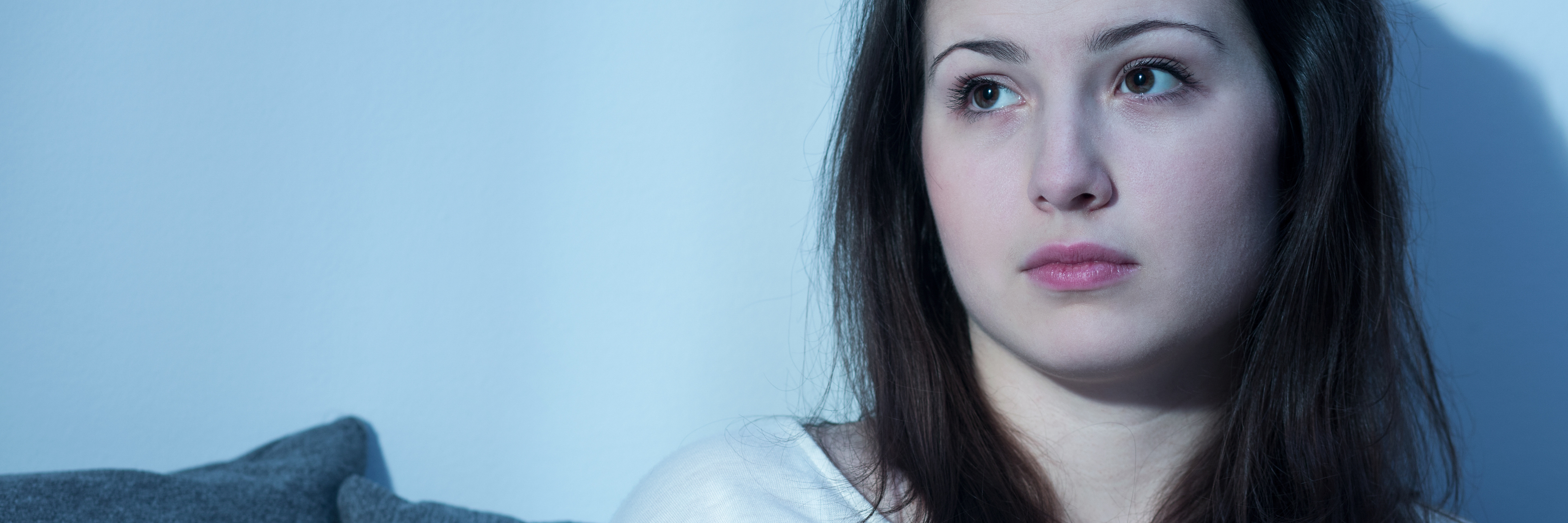 Why 'Reset Days' Are Important When You Have Depression young woman sitting upright in bed with depression