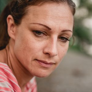 Upset woman, looking to her side.