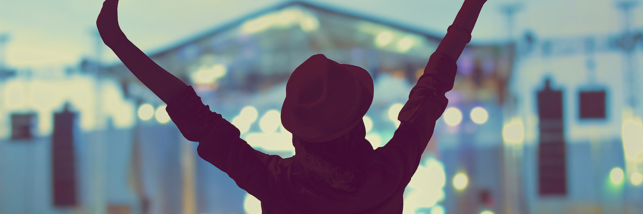 8 Ways to Keep Your Mental Health in Check at Summer Music Festivals Girl enjoying the music festival / concert.