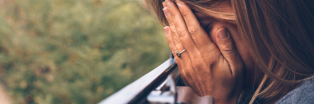 The Work I Do Now in My Son’s Honor After His Suicide A woman with her head in her hands