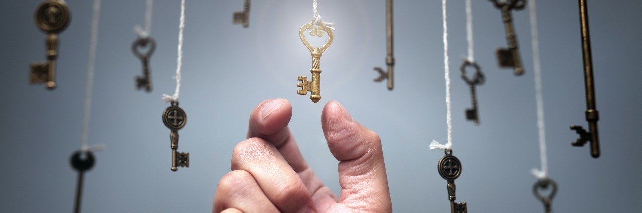 Why It's Hard to Make Decisions With a Chronic Condition Keys are dangling from ceiling as a hand reaches up to pick one.