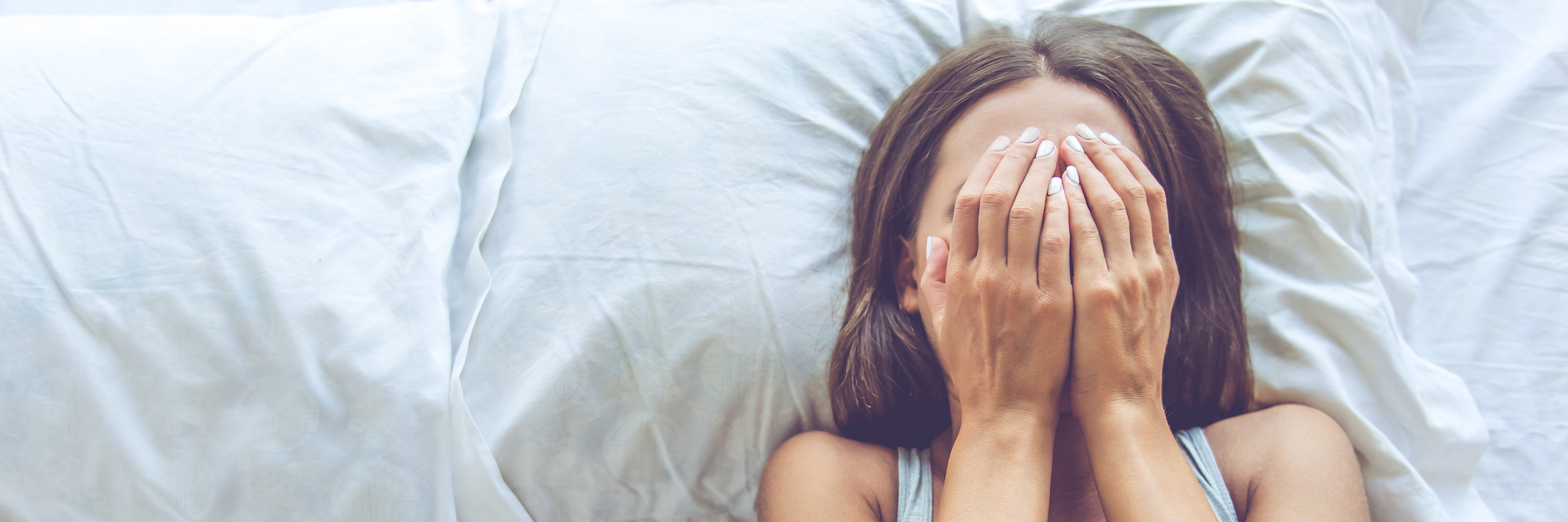 Teaching My Students About My 'High-Functioning' Bipolar Disorder woman covering her face in bed