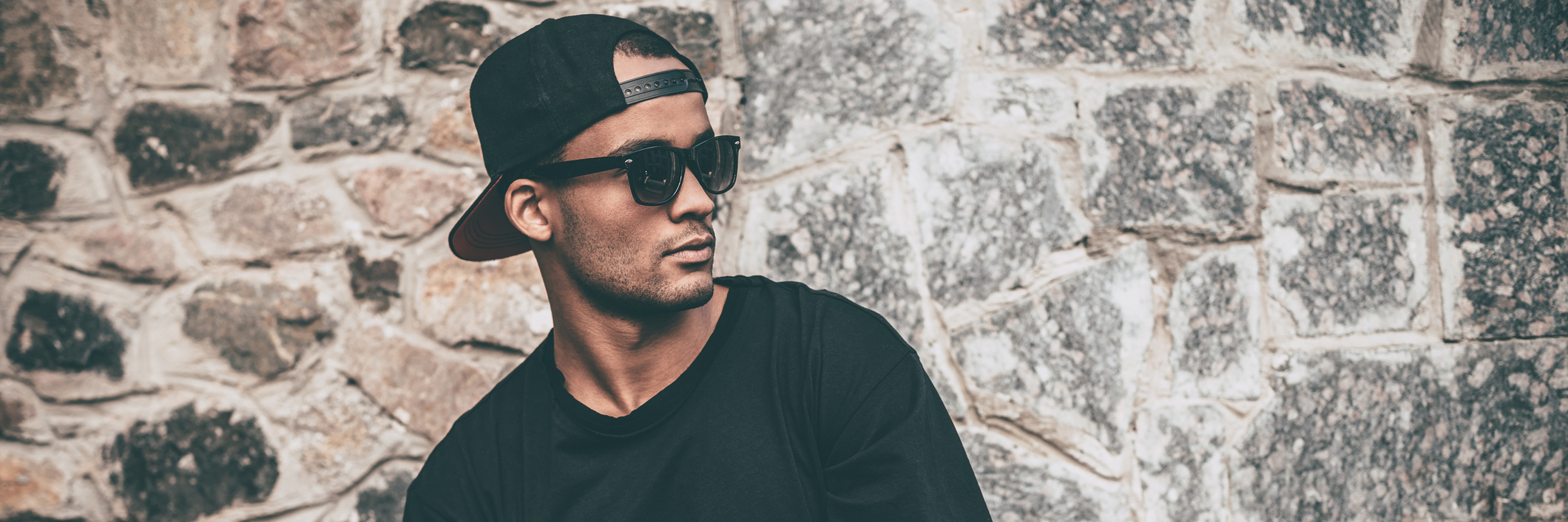 Why I 'Fake It 'Til I Make It' With 'High-Functioning' Anxiety Handsome young African man in cap and sunglasses standing against the stoned wall and looking away