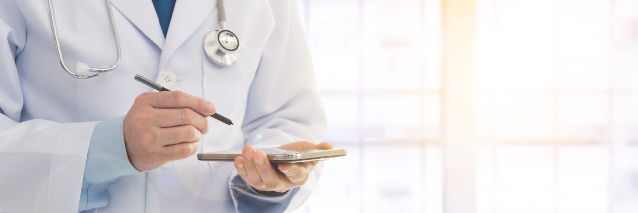 I Don't Want to Be Labeled 'Noncompliant' as a Psychiatric Patient Doctor using a smart phone in hospital. Concept of medical appointment, communication.