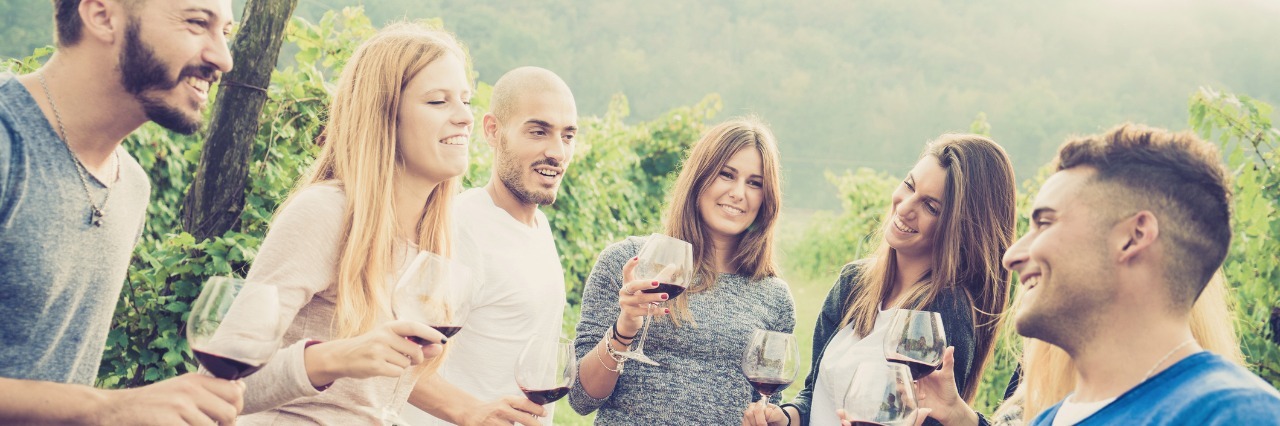 What to Know About Living With Adult Onset Food Allergies friends standing around a table drinking before eating