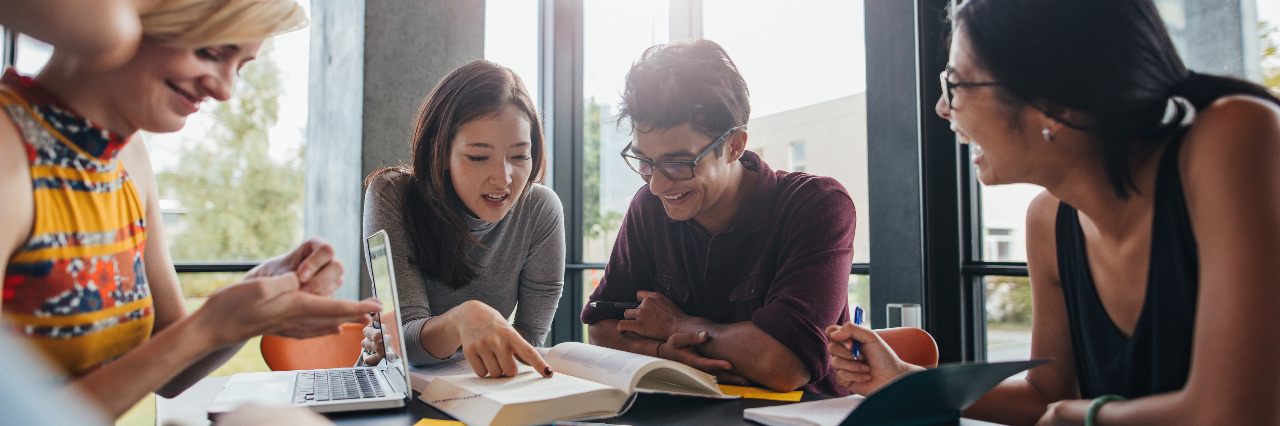 University students studying in library.