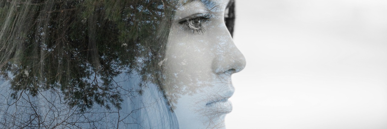 double exposure picture of a young woman and a forest