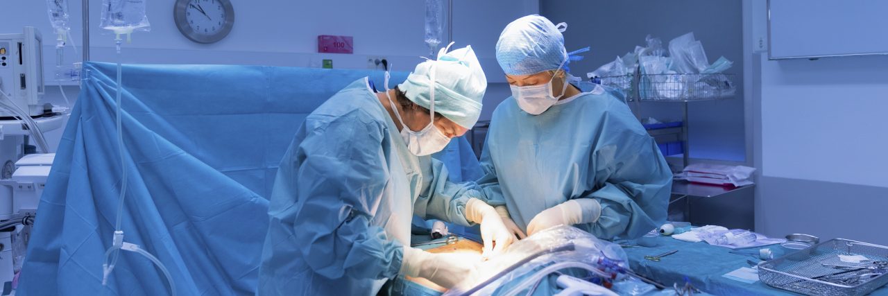 Getting Selective Dorsal Rhizotomy as an Adult With Cerebral Palsy Surgeons performing surgery in operating room.