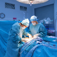 Surgeons performing surgery in operating room.