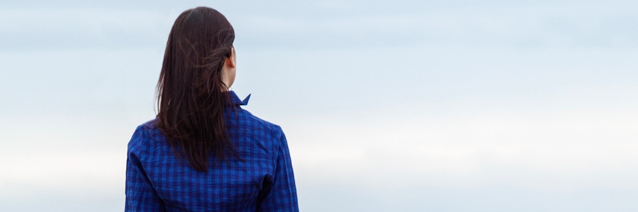 Memories and Mother's Day After the Loss of My Mom Woman facing sky with light clouds