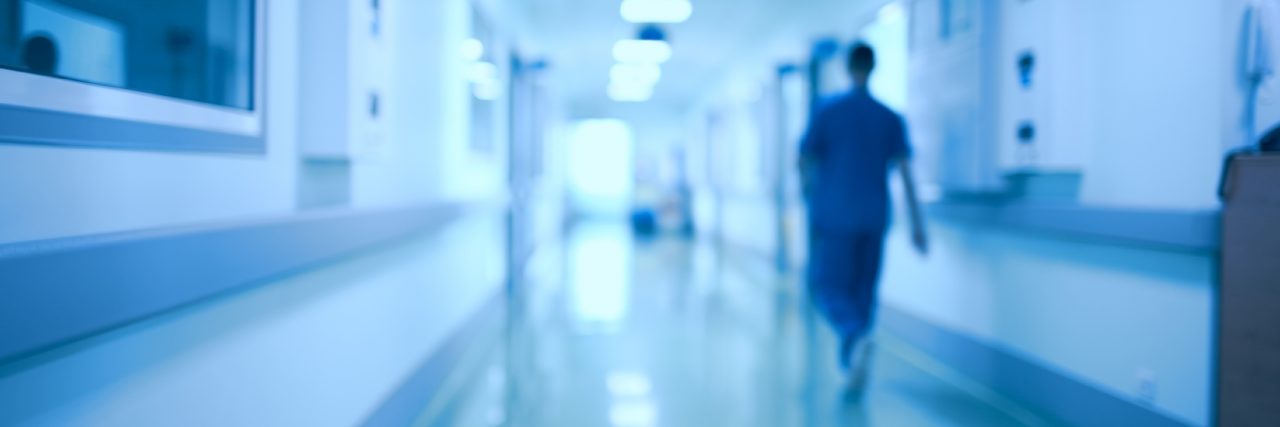 Hospital Administrations Vs. Doctors Helping Rare Disease Patients Hospital corridor and doctor as a blurred defocused background