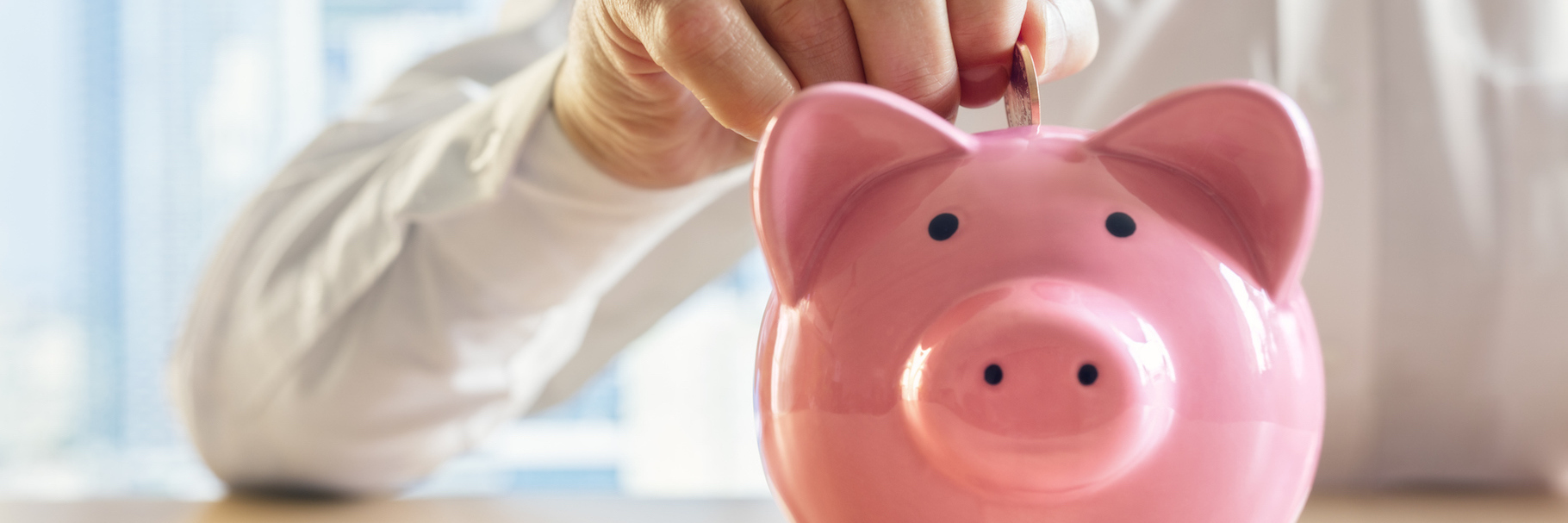 6 Ways to Help Manage Your Mental Health That Won't Break the Bank Woman putting change in a piggy bank