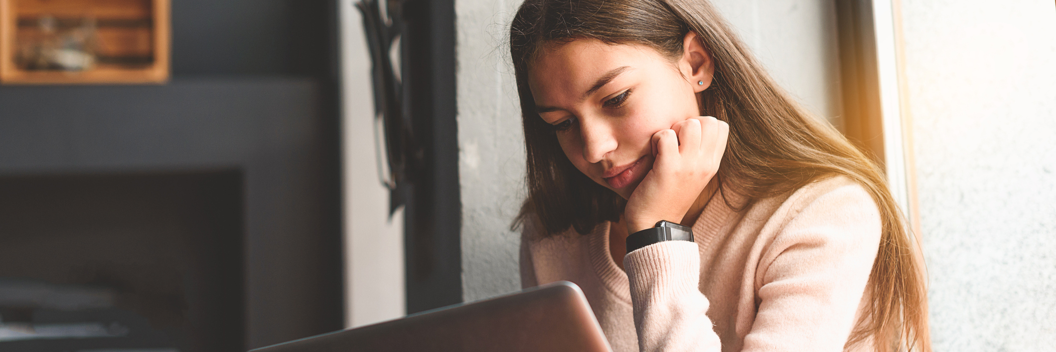 The Realities of Being a Teen With a Life-Threatening Condition A teen girl sits at her computer.