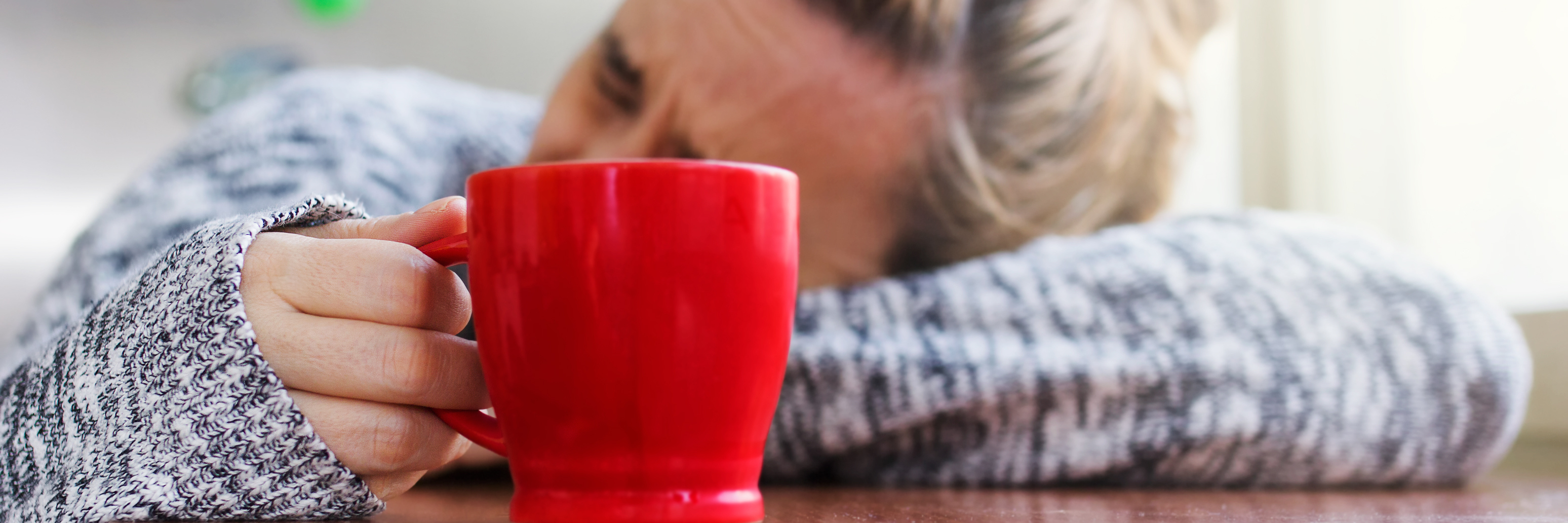 Why My Chronic Illness Makes Me Feel Sick After I Have Fun woman laying on a table with a mug in hand