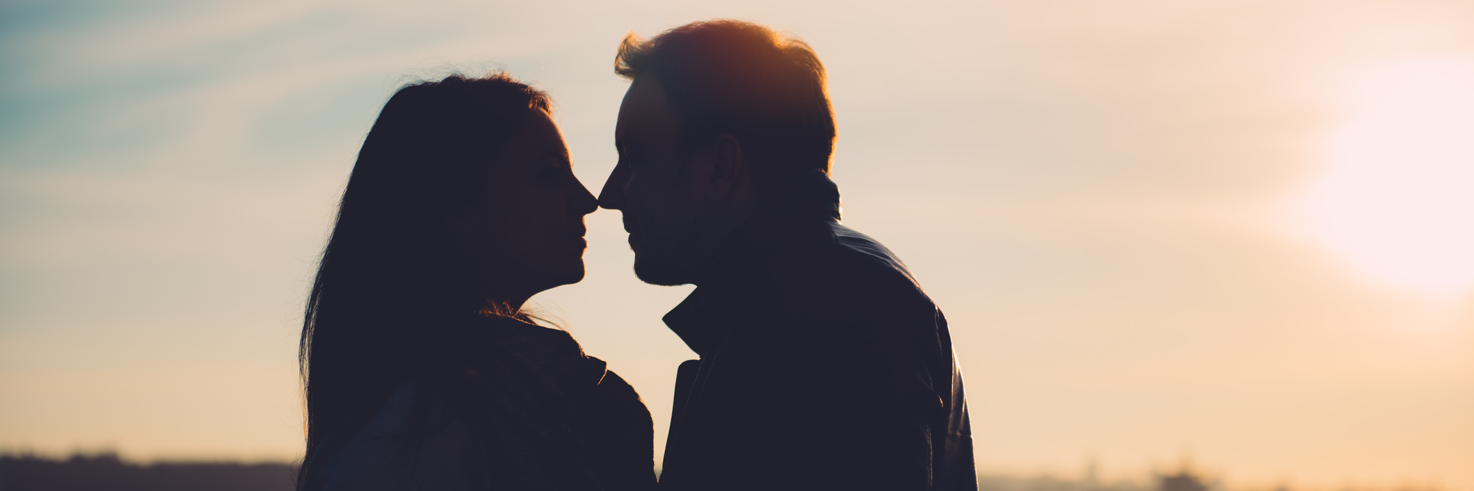 silhouette of a couple looking at each other