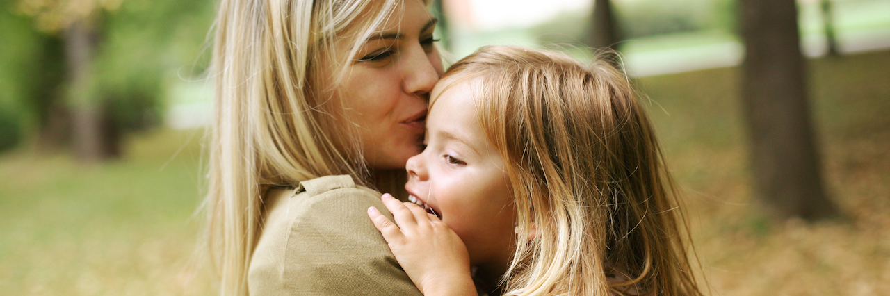 Balancing Motherhood and Mental Illnesses A mother and her daughter hugging outside