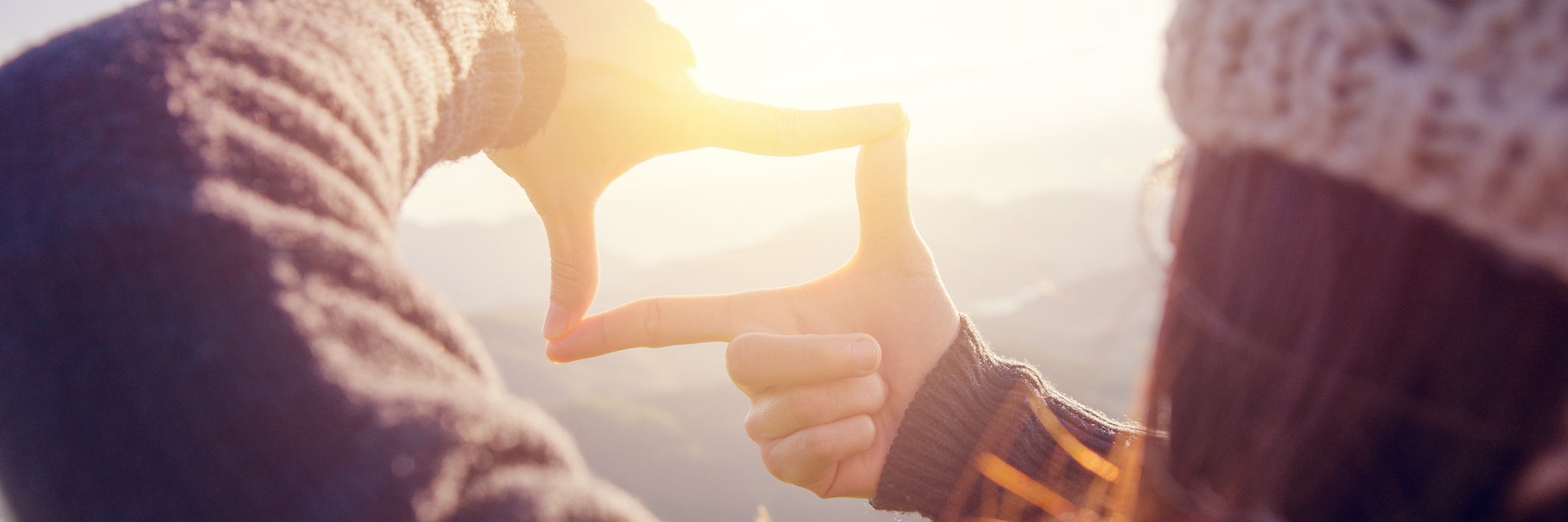 My Life With Aphantasia Woman hands making frame gesture with sunrise.
