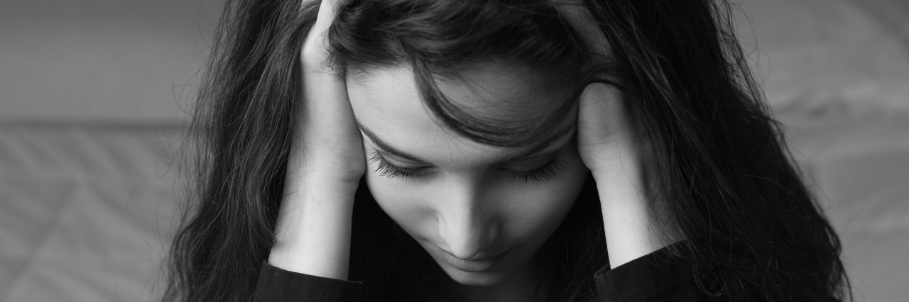 What a Hemorrhagic Stroke Felt Like woman holding head due to headache