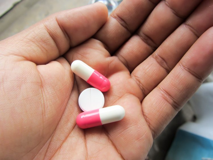 Medicine pill and capsules in hand