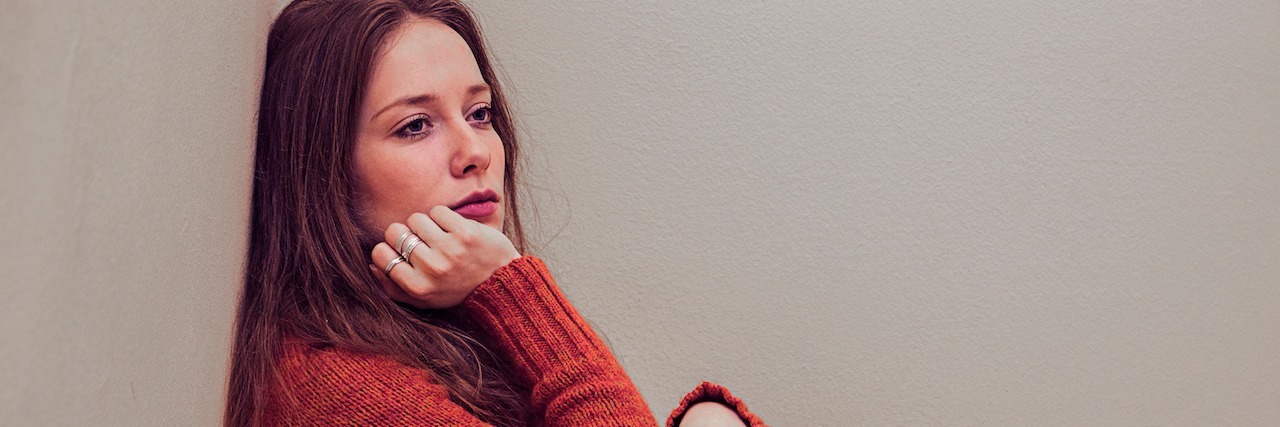 What It Feels Like to Have an 'Anxiety Hangover' A woman sitting in the corner