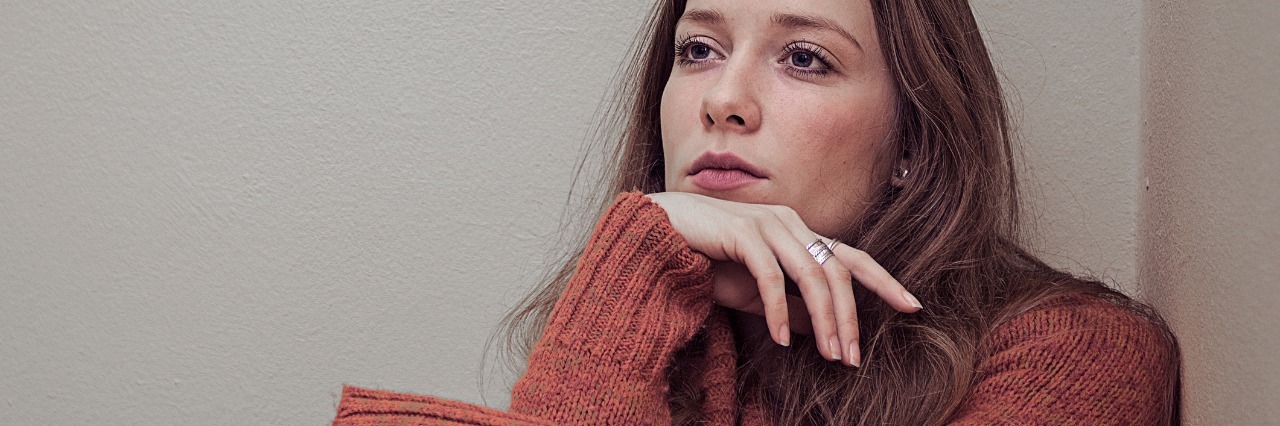 When You're Always Anxious Someone Is Angry at You woman looking anxious sitting in corner